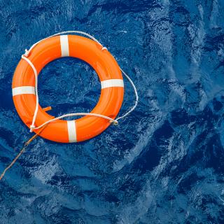 Safety equipment, Life buoy or rescue buoy floating on sea to rescue people from drowning man.